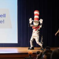 Cat in the Hat mascot characters enters auditorium on stage